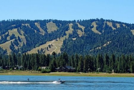 Summer water skier at Big Bear Lake and the mountain behind for winter snow skiing