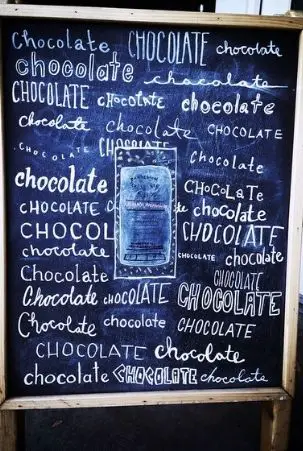 Chalkboard sign celebrating chocolate at Dandelion Chocolate Factory in San Francisco's Mission District.