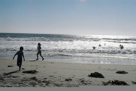 Kids playing on Mission Beach in San Diego, CA